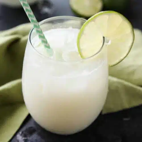 Brazilian Lemonade is actually a creamy limeade that is perfectly sweet and slightly tangy. The secret ingredient that makes it creamy will have you pouring glass after glass of this refreshing drink. Perfect for hot summer days, parties, and potlucks!