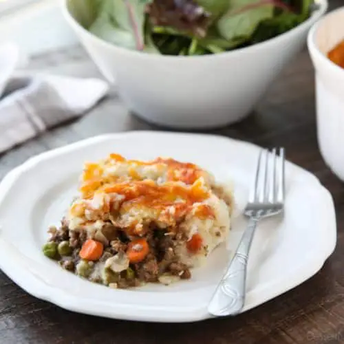 This Shepherd's Pie is a hearty and simple dinner made with ground beef and veggies in a flavorful broth topped with fluffy garlic mashed potatoes and a sprinkle of cheese. Classic comfort food for cold weather months or to celebrate St. Patrick's Day.