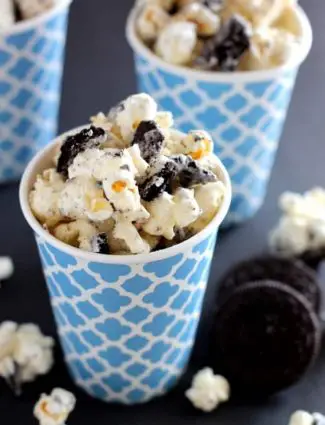 Cookies and Cream Popcorn - white chocolate and Oreos come together to flavor this air popped corn! From DessertNowDinnerLater.com