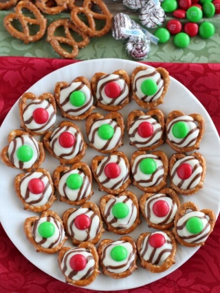 These festive Christmas Pretzel Hugs are melted just enough to press an M&M on the top. Let the chocolate set back up and then package them for neighbor gifts, or place them on a plate for the perfect salty-sweet treat! From DessertNowDinnerLater.com