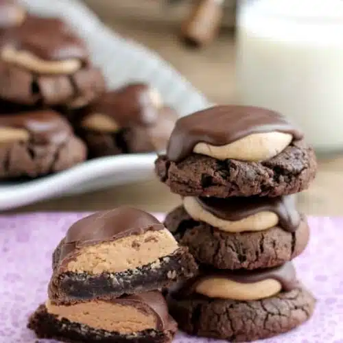 Buckeye Cookies - a chocolate brownie cookie base, topped with peanut butter balls, all covered in chocolate! These are insanely delicious!