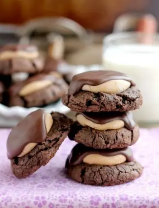 Buckeye Cookies - a chocolate brownie cookie base, topped with peanut butter balls, all covered in chocolate! These are insanely delicious!