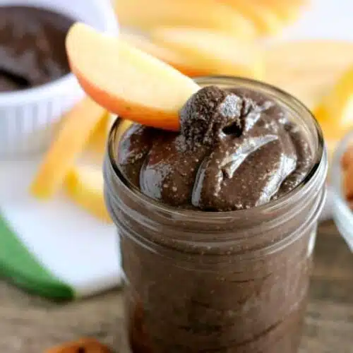 This Dark Chocolate Honey Almond Butter is made with pure ingredients for a healthy homemade spread great on toast, as a dip for apples and bananas, or eaten straight from the spoon! (Bonus! It's Gluten Free, Paleo, and can easily be turned into Vegan.)