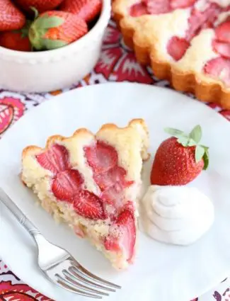 This Strawberry Cake is lightly sweet, layered with fresh sliced strawberries, and is served with a side of coconut whipped cream. A stunning and delicious dessert for any occasion or Valentine's Day.