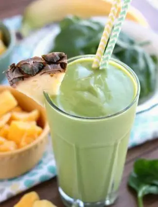 This Tropical Green Smoothie uses tender spinach leaves, plain non-fat greek yogurt, and frozen fruit for a naturally sweet smoothie that's great for breakfast or a snack!