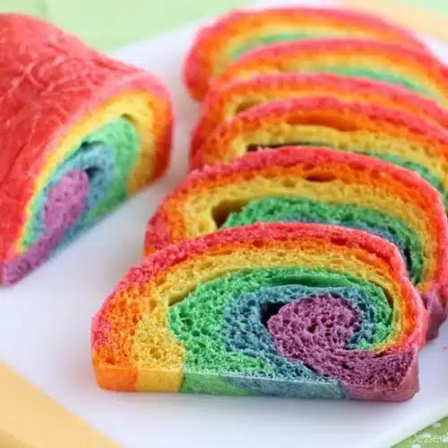 Rainbow Bread - Rhodes frozen dough is kneaded into 6 bright colors and rolled into a fun rainbow loaf (step-by-step photo instructions included). The perfect bread to eat with butter for dinner or use for breakfast french toast on St. Patrick's Day!