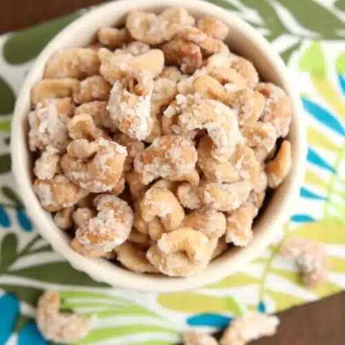 These Coconut Cashews, inspired by Trader Joe's, are made with coconut milk, coconut oil, sugar, and coconut flakes to create some incredibly delicious candied nuts!