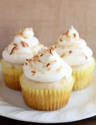 These Pina Colada Cupcakes have crushed pineapple in the cake, and coconut & rum extracts in the frosting, for a frozen drink inspired tropical dessert!