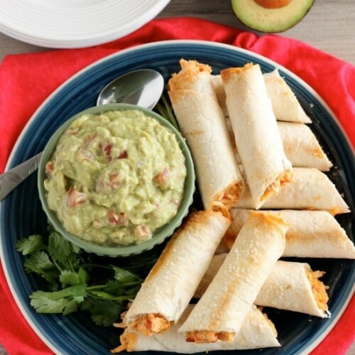 These Zesty Baked Chicken Taquitos are creamy and cheesy with a special ingredient to make them bold and zesty! A simple guacamole recipe is also included!