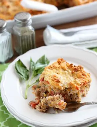 Savory Breakfast Bread Pudding has sausage, tomatoes, eggs, and herbs all in a cheesy bread pudding.