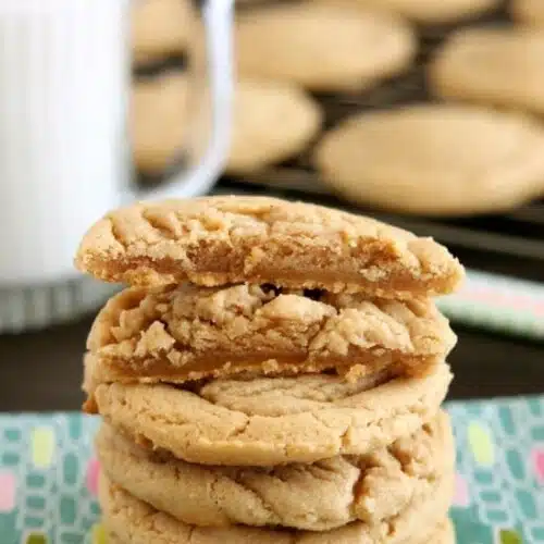 These Thick and Chewy Peanut Butter Cookies are slightly crisp on the outside, tender and soft on the inside, plus you just scoop and bake them! No rolling in sugar and pressing with a fork required!