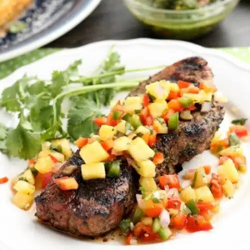 This restaurant-quality steak is marinated in an herbed chimichurri sauce, grilled to perfection, and topped with a spicy-sweet pineapple salsa.