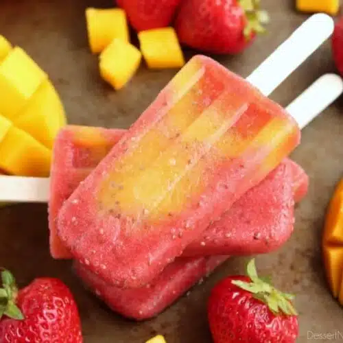 Beat the summer heat with these Strawberry Mango Chia Popsicles! Fresh fruit, chia seeds, and coconut water is all you need to whip up these hydrating pops.