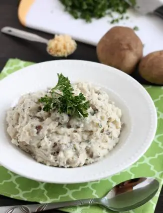 These Slow Cooker Mashed Potatoes are packed with flavor thanks to garlic and herbs, and making them in the slow cooker is the best solution for your Thanksgiving or Christmas dinner!