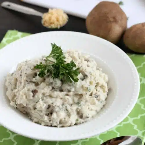 These Slow Cooker Mashed Potatoes are packed with flavor thanks to garlic and herbs, and making them in the slow cooker is the best solution for your Thanksgiving or Christmas dinner!