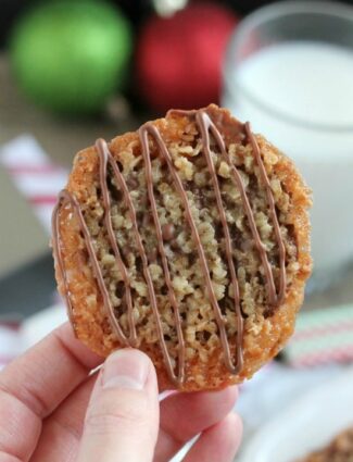 Thin, crisp, buttery cookies are sandwiched between melted milk chocolate with an extra chocolate drizzle on top. They taste like toffee and they look like lace. These Florentine Cookies are a holiday favorite!