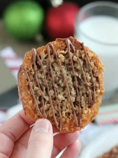 Thin, crisp, buttery cookies are sandwiched between melted milk chocolate with an extra chocolate drizzle on top. They taste like toffee and they look like lace. These Florentine Cookies are a holiday favorite!