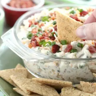 A loaded baked potato inspired this chip dip full of bacon, cheese, green onions, and ranch dressing mix. A delicious party dip or game day appetizer.