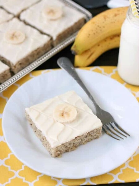 This is the BEST banana cake topped with the BEST cream cheese frosting! Perfect for picnics and potlucks, this banana sheet cake is a crowd pleaser! Everyone asks for the recipe!