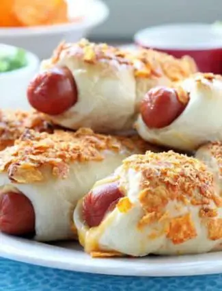 Frozen dough, nacho tortilla chips, and extra cheese transform ordinary pigs in a blanket into these extraordinary crunchy nacho dogs.