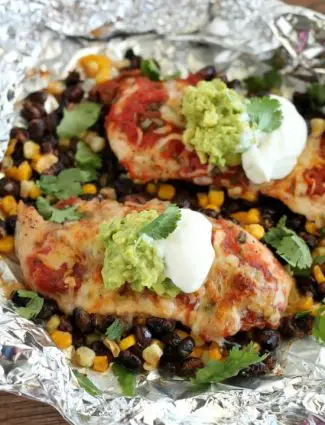 These Southwestern Chicken Packets are an easy and delicious tin-foil dinner recipe you can cook with a fire (while camping), on a grill, or in an oven.