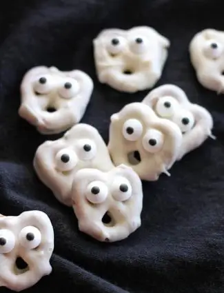 Ghost Pretzels - White chocolate dipped pretzels are made into ghosts with candy eyes and a little bit of imagination.