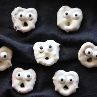 Ghost Pretzels - White chocolate dipped pretzels are made into ghosts with candy eyes and a little bit of imagination.