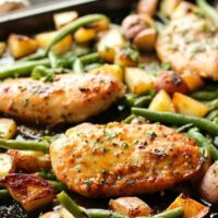 This one pan chicken dinner has the most delicious honey garlic glazed chicken alongside tenderly roasted potatoes and green beans. Plus, it's so easy and flavorful, you'll make again and again!