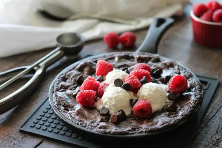 This fudgy skillet brownie is made with a boxed mix for a quick dessert for two! Eat it warm from the oven topped with ice cream, chocolate chips, and fresh raspberries for an extra special treat!