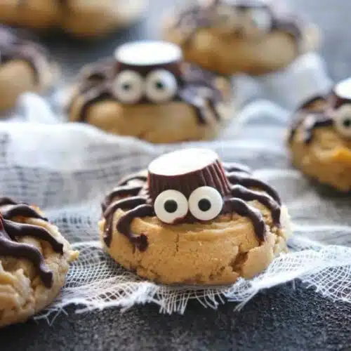 Not all Halloween food has to be gross and gory! These super cute spider cookies are made with peanut butter cups, chocolate, candy eyes, and the BEST peanut butter cookie recipe you'll ever try!