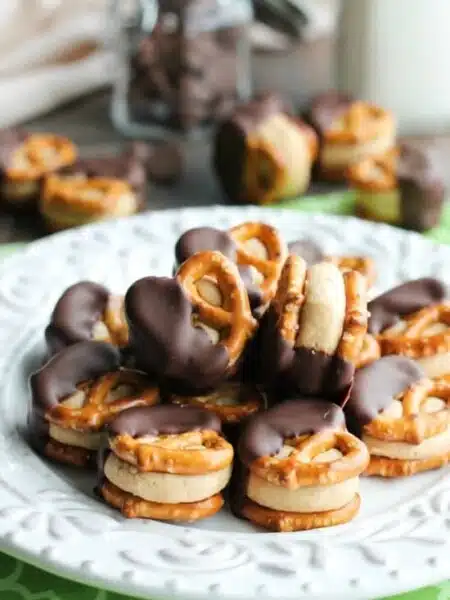 Peanut Butter Balls are made into pretzel bites for a salty-sweet addicting treat! Perfect for parties or Christmas neighbor gifts!