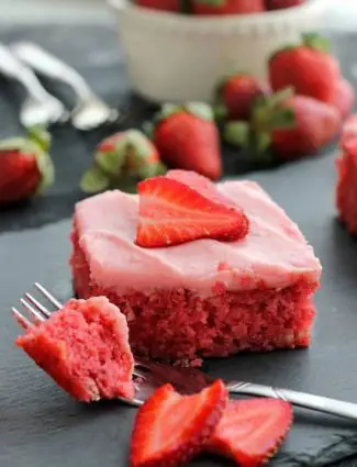 This strawberry cake uses fresh strawberries and flavored gelatin for a super flavorful strawberry sheet cake that will feed a crowd. It's really easy, and incredibly moist too!