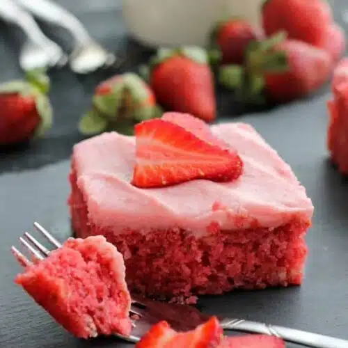 This strawberry cake uses fresh strawberries and flavored gelatin for a super flavorful strawberry sheet cake that will feed a crowd. It's really easy, and incredibly moist too!