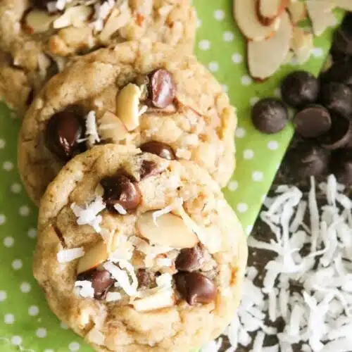 Almond Coconut Chocolate Chip Cookies are loaded with sliced almonds, shredded coconut, chocolate chips and flavored extracts for an Almond Joy inspired twist on the traditional chocolate chip cookie.