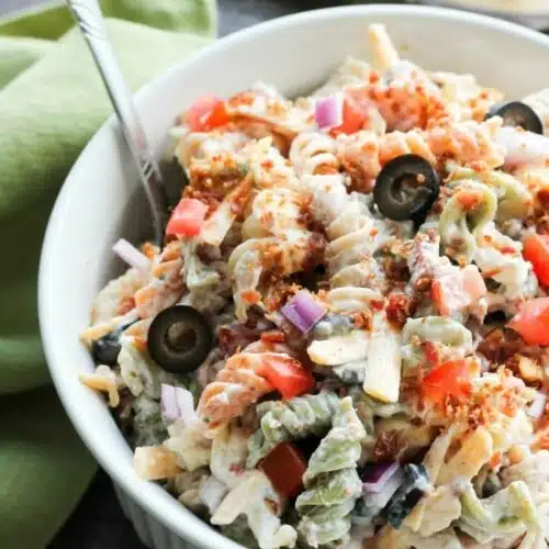 Bacon Ranch Pasta Salad is perfect for BBQ's and all your summer get togethers. It's loaded with pasta, bacon, cheese, olives, tomatoes, and onion then tossed with a simple, creamy ranch dressing.