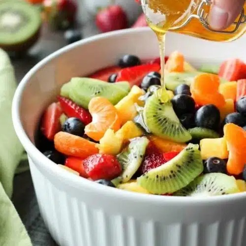 This summer fruit salad is as colorful as a rainbow, and is tossed in a reduced honey orange glaze for the perfect amount of added sweetness and flavor. Great for barbecues, potlucks, and picnics!