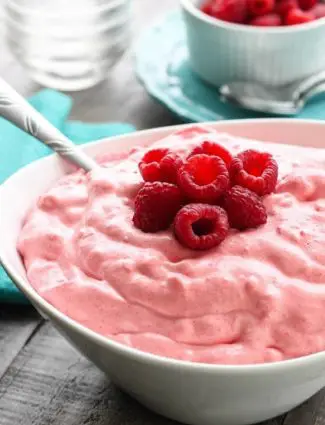 Raspberry Fluff Fruit Salad is the jello salad that everyone loves! With only 4-ingredients and 5 minutes prep, this is the perfect sweet side dish for your next potluck, picnic, or BBQ!