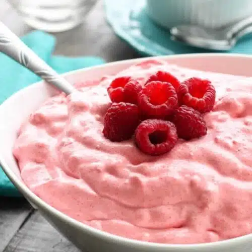 Raspberry Fluff Fruit Salad is the jello salad that everyone loves! With only 4-ingredients and 5 minutes prep, this is the perfect sweet side dish for your next potluck, picnic, or BBQ!