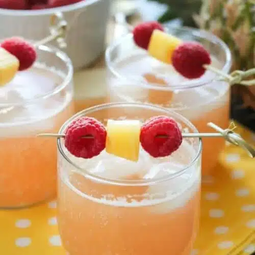 Raspberry Pineapple Punch is fruity, fizzy, and family friendly. Great for your summer party or baby shower.