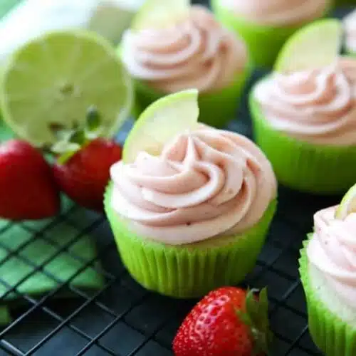 Strawberry Lime Cupcakes are perfect for summer, with a tangy lime cupcake base and sweet strawberry frosting they are sure to be loved by all. A family-friendly, non-alcoholic alternative to strawberry margarita cupcakes!