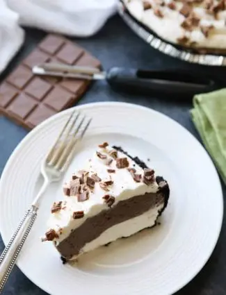 This no bake cheesecake has two layers of light and smooth cheesecake -- creamy vanilla and decadent chocolate, layered inside a chocolate cookie crust, and topped with sweetened whipped cream and chocolate shavings. It's an easy and delicious summer dessert!