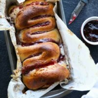 Intestines Bread is a fun halloween party food that makes you look twice. All it really is, is a sweet pull apart bread with cream cheese and raspberries.