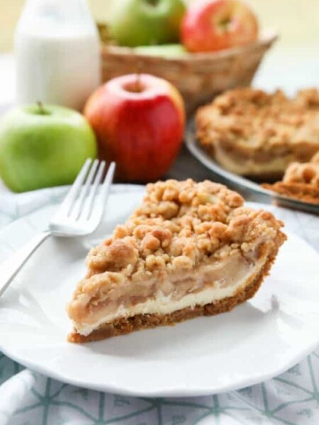 Apple Streusel Cheesecake Pie combines two dessert favorites with a graham cracker crust, creamy cheesecake layer, homemade apple pie filling, and crunchy streusel topping.