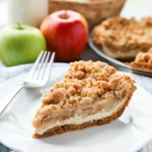 Apple Streusel Cheesecake Pie combines two dessert favorites with a graham cracker crust, creamy cheesecake layer, homemade apple pie filling, and crunchy streusel topping.