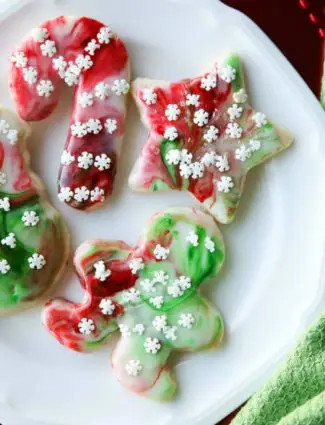 Swirled Christmas Sugar Cookies make cookie decorating easy! Simply swirl food coloring in a special glaze and dip the cookie! The kids will love making these for Santa! 