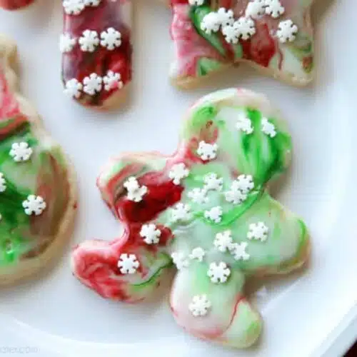 Swirled Christmas Sugar Cookies make cookie decorating easy! Simply swirl food coloring in a special glaze and dip the cookie! The kids will love making these for Santa! 