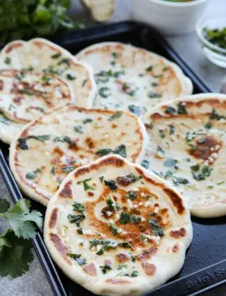 This buttery Garlic Naan flatbread is made easy with store-bought frozen dough. Enjoy restaurant-style Indian bread with dinner anytime, it's so easy!