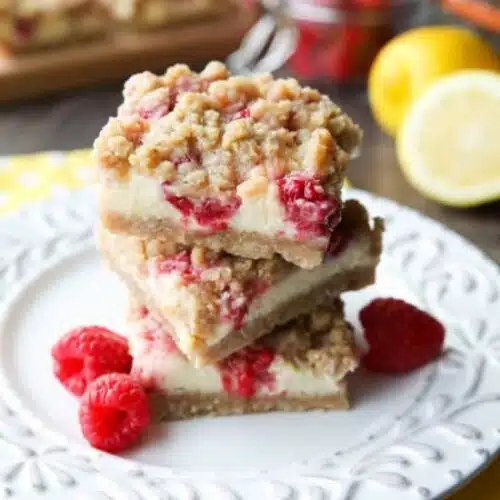 Lemon Raspberry Crumb Bars have a creamy and tangy-sweet filling sandwiched between a brown sugar and oat crust that doubles as the crumb topping. These dessert bars are to die for!