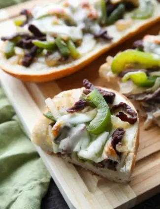 Philly Cheesesteak French Bread is a delicious open-faced sandwich with plenty of juicy meat, crisp veggies, and melty cheese for an easy dinner that is sure to satisfy!