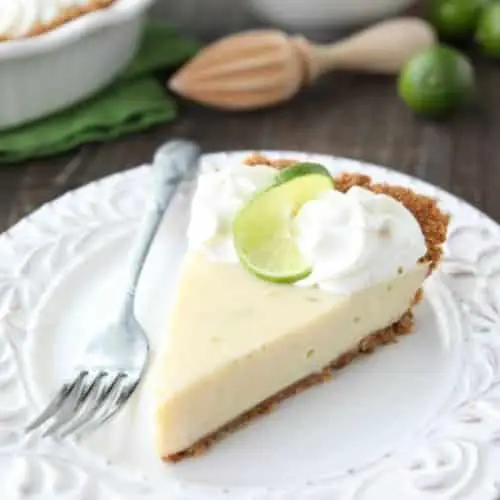 This classic Key Lime Pie recipe is smooth and creamy, tart yet sweet, and super easy to make! Top it with freshly sweetened whipped cream for the perfect bite!